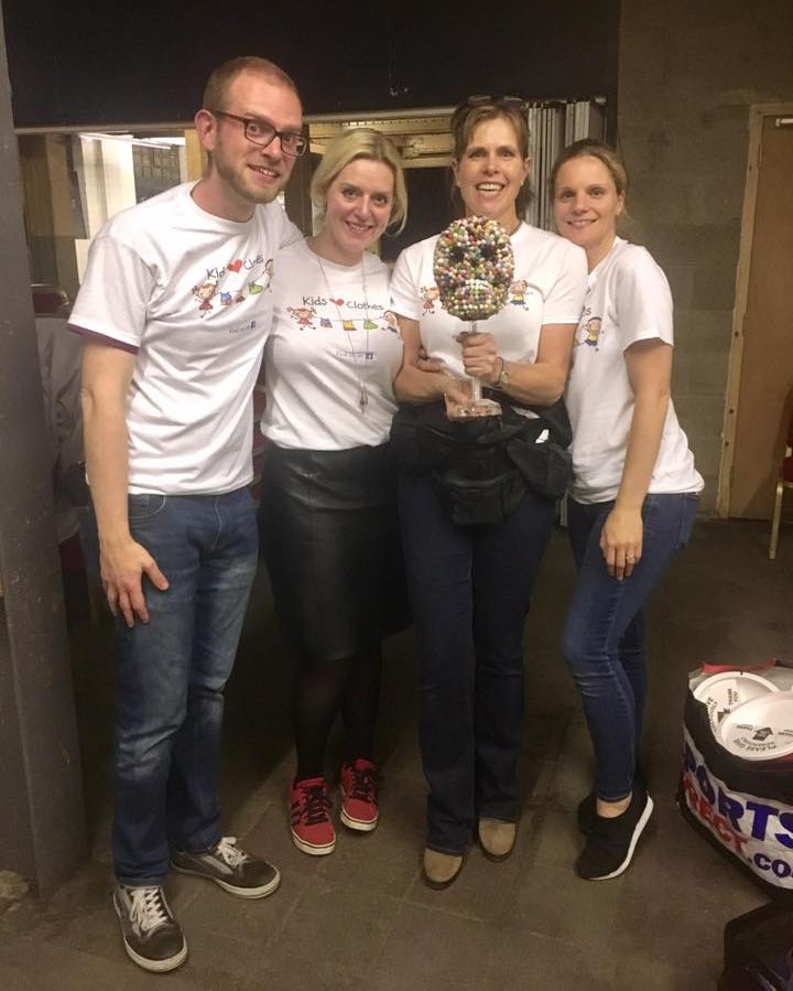 four volunteers holding a trophy